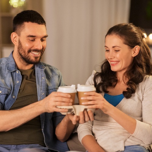 Couple Enjoying Coffee In Living Room
