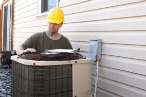 Technician Looking At Ac Unit